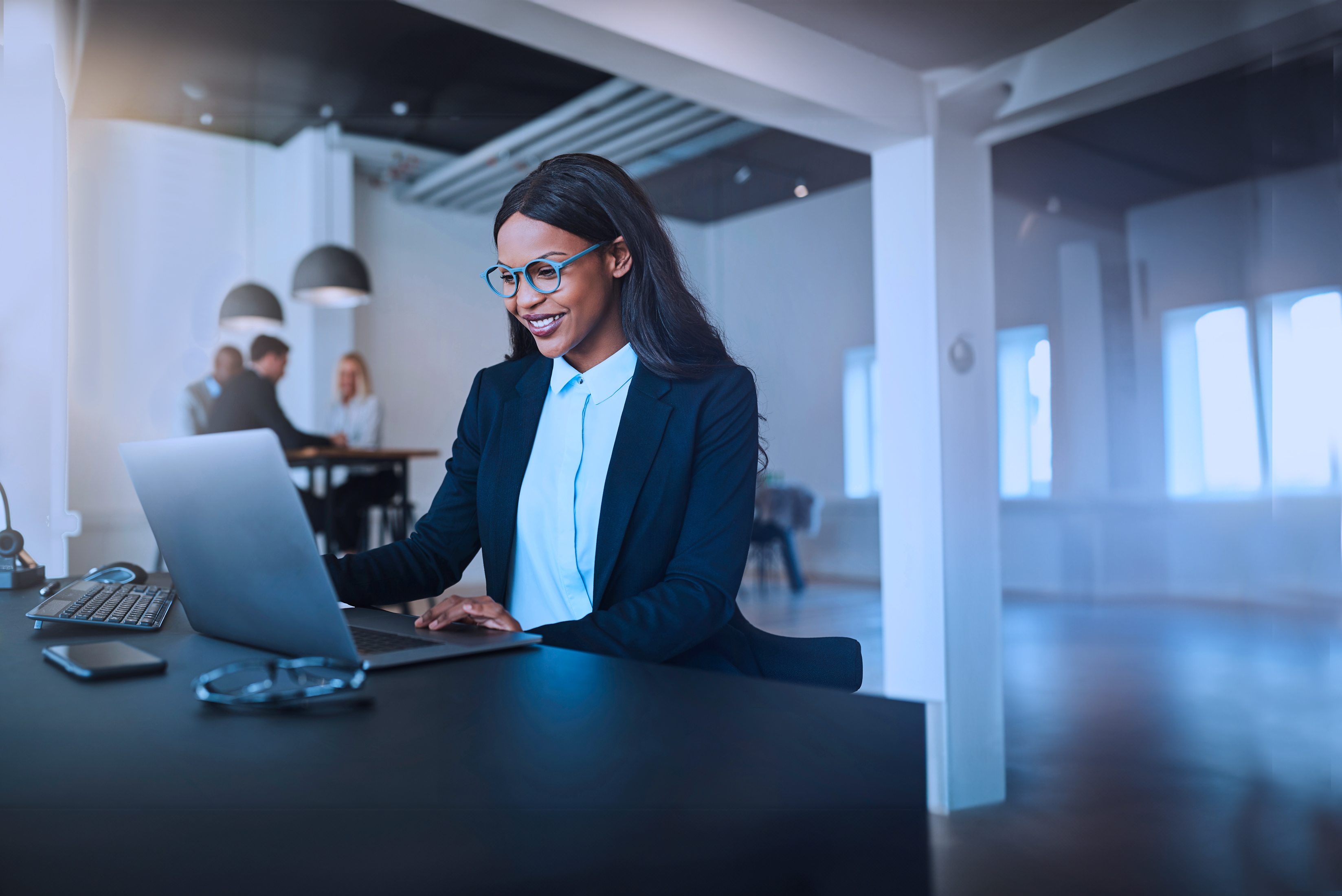 Young black business woman working on laptop